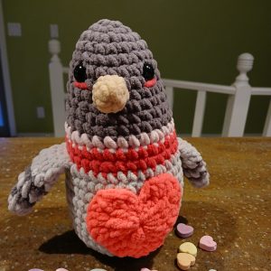 Grey Crocheted Pigeon Wearing a Cardigan with a Red Heart